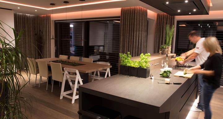Kitchen and dining table lit with smart lighting
